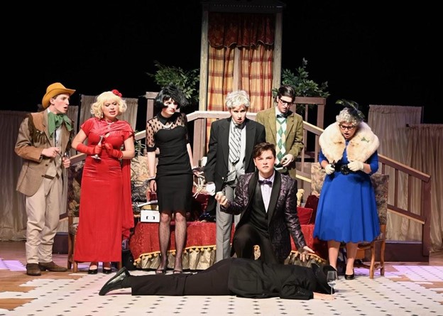 Colonel Mustard (Wade Slatcher), Miss Scarlet (Lexi Sennowitz), Miss White (Mills Crosland), Wadsworth (Sara Mack Lowe), Mr. Green (Patrick Rodrigue), Miss Peacock (Harper Purcell), and Professor Plum (Charlie Sanderlin) examine Mr. Body’s (Eliza Connolly) dead body. Photo courtesy of Eliza Connolly.