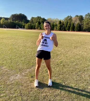 Josie Collins smiling during a track meet. 