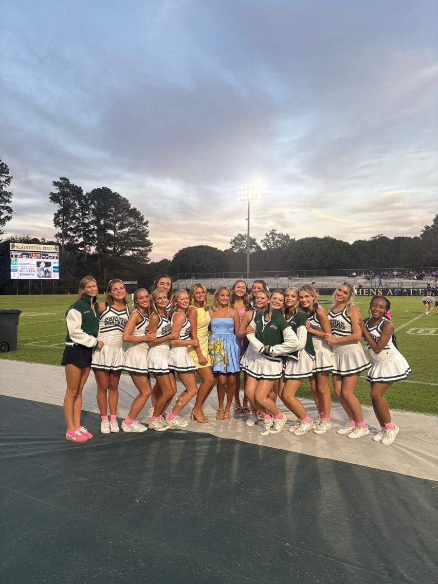 The Queen's court with the varsity cheerleaders at the homecoming game.